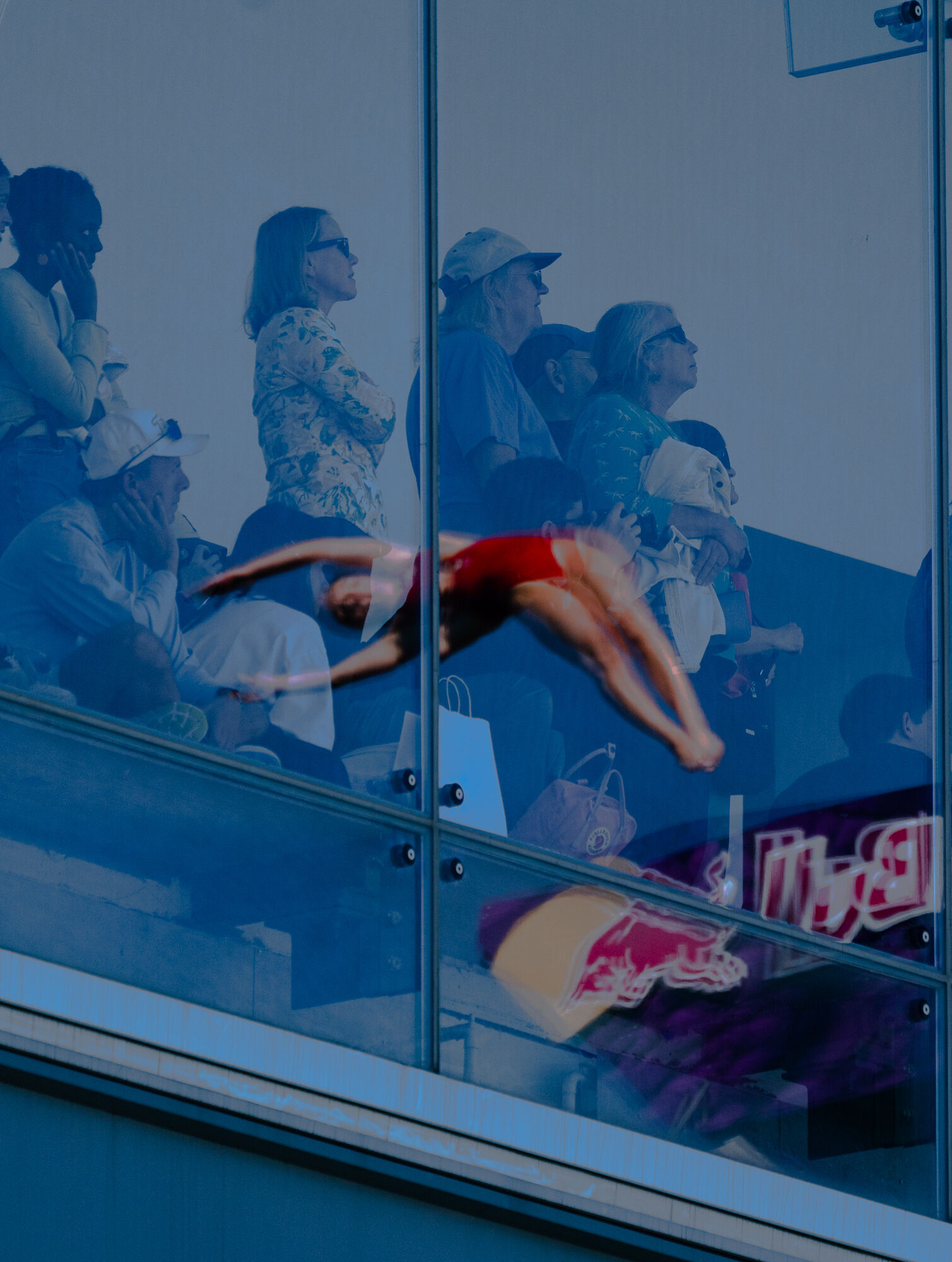 Simone Leathead (CAN) in her fourth dive, reflected in the windows of the ICA. A few lucky onlookers are allowed in the museum this morning.